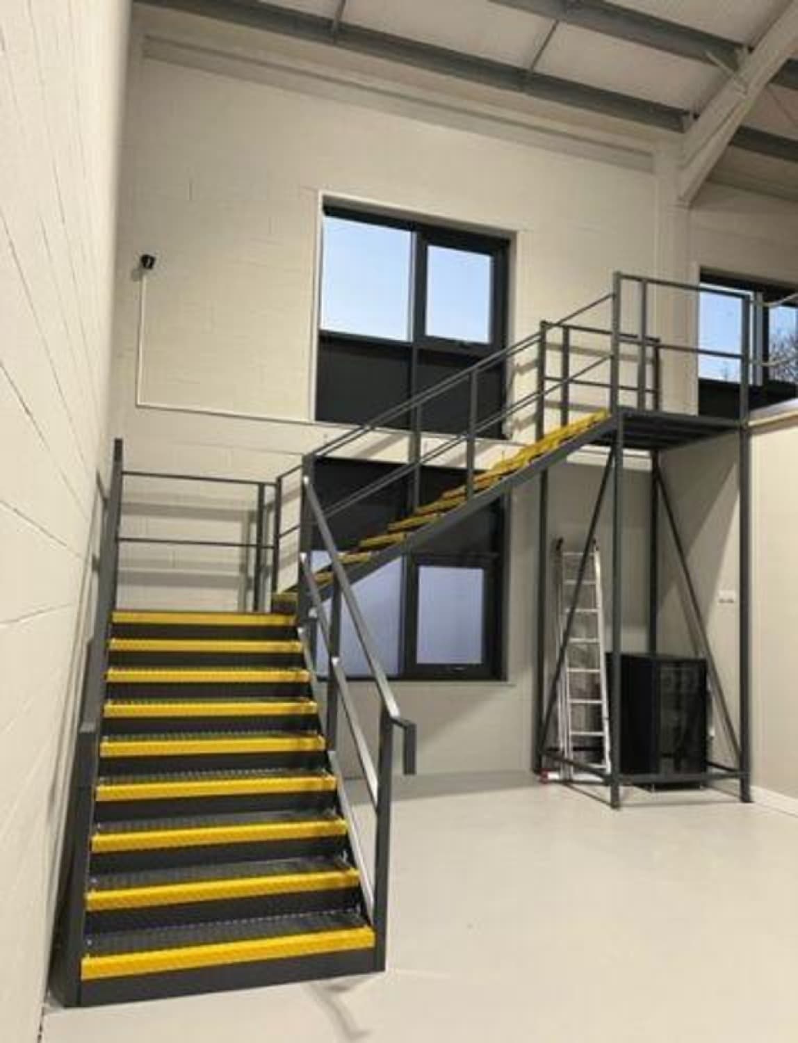 Office space built on a steel mezzanine floor, where occupancy and escape routes matter